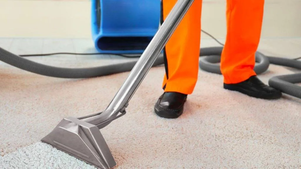 Orange pants vacuum man