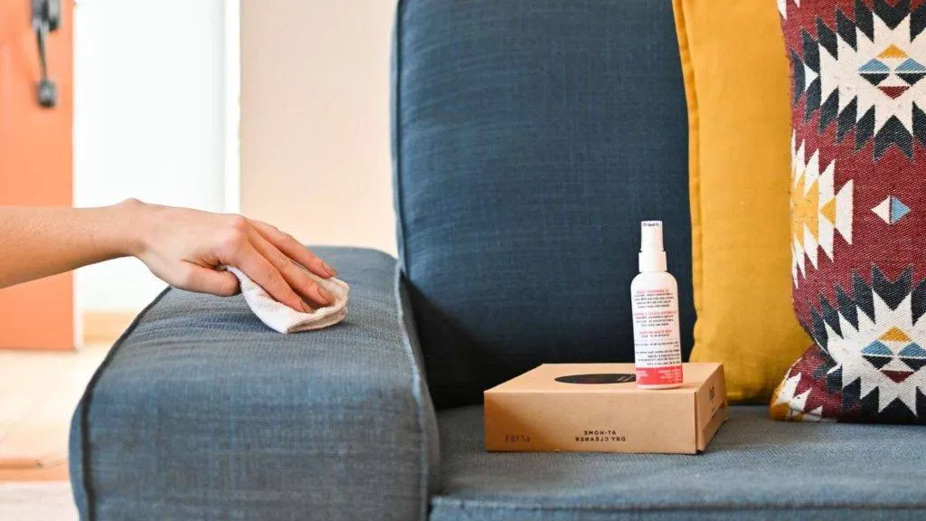 Spot cleaning on a blue couch